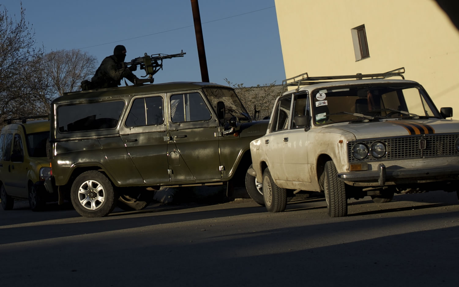 A vehicle with a gunman on it's roof drives towards the gate of the Belbek airbase outside Sevastopol, Crimea, on March 22.
