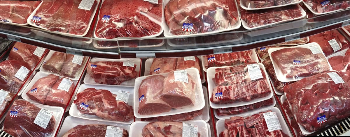 Various cuts of beef and pork are displayed for sale in the meat department at a discount market in Arlington, Va. Every five years, the government tells Americans how to eat healthier.