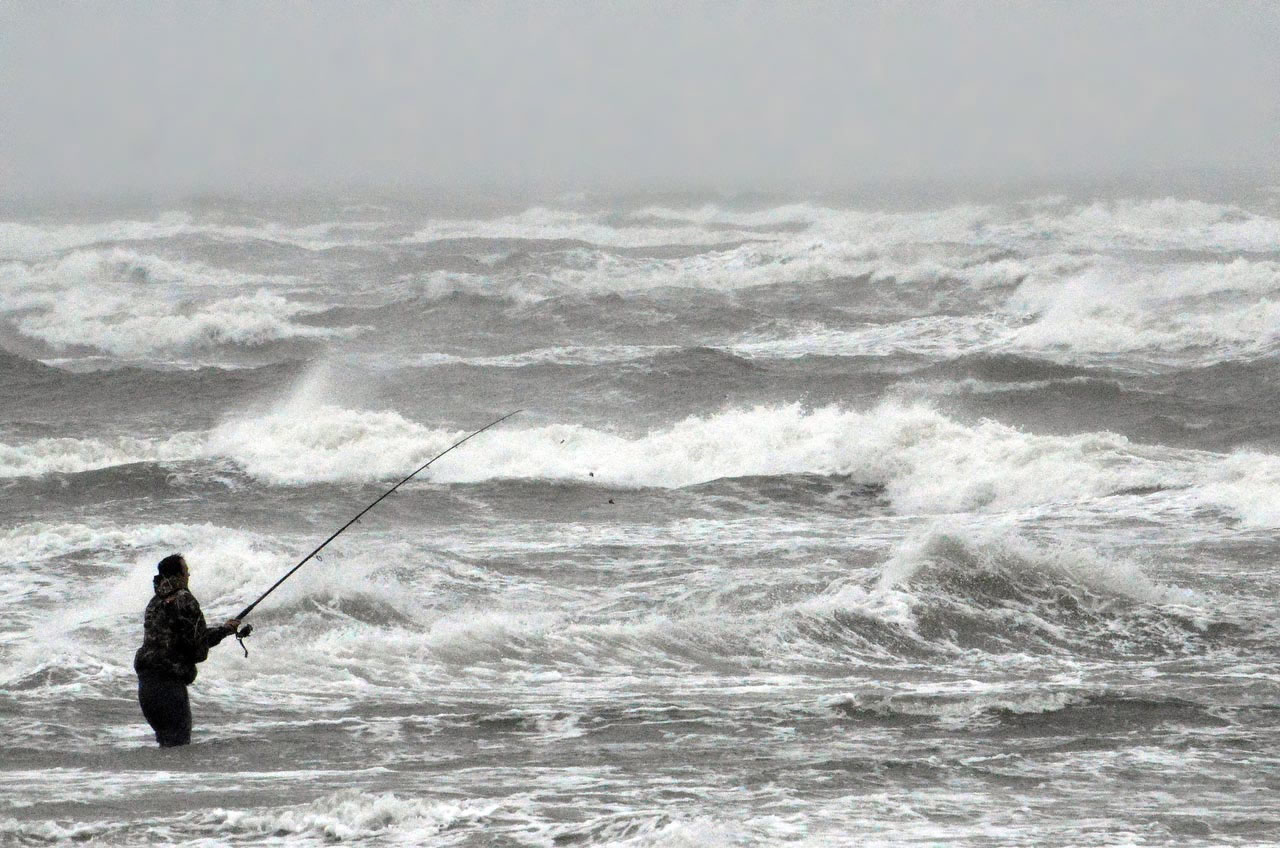 Luke Seymour, of Canton, N.Y., braves 30-knot winds and heavy surf to try his luck fishing Thursday off the Second Avenue beach in North Wildwood, N.J. New Jersey Gov. Chris Christie has declared a state of emergency ahead of a storm expected to bring heavy rain and flooding.
