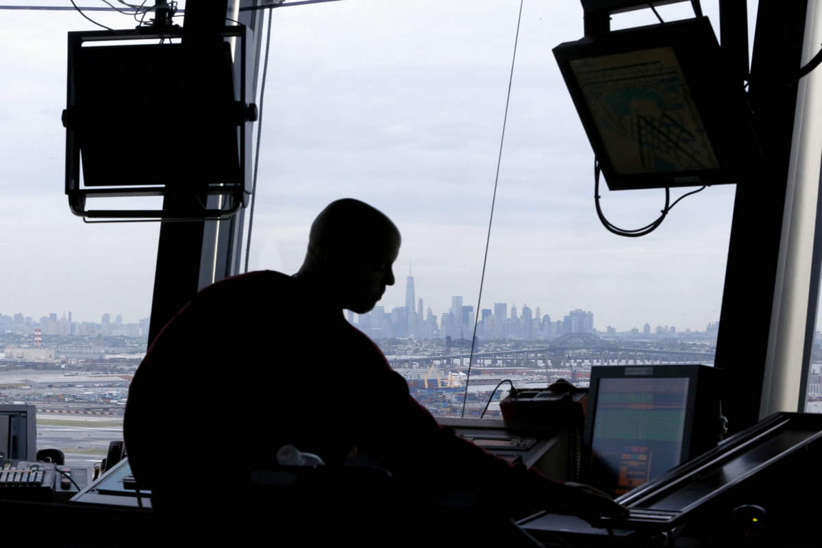An air traffic controller works in the tower in May at Newark Liberty International Airport in Newark, N.J.