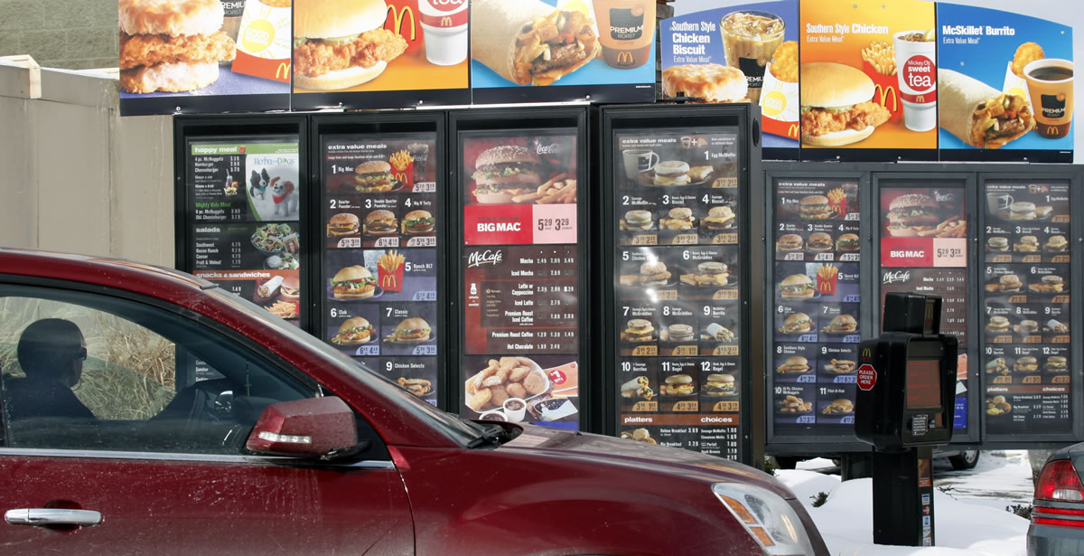 A customer looks at the menu at a McDonald's drive-thru in 2009 in Williamsville, N.Y.