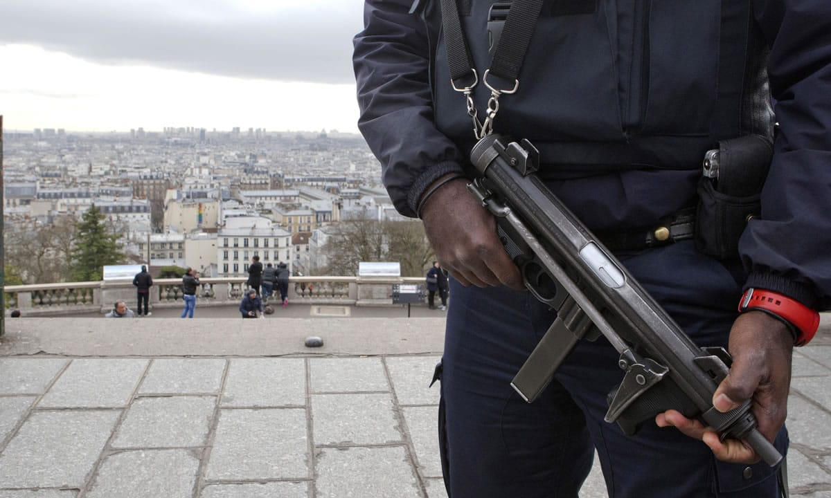 A French police officer patrols around the Sacre Coeur basilica at Montmartre district, in Paris,, on Monday.