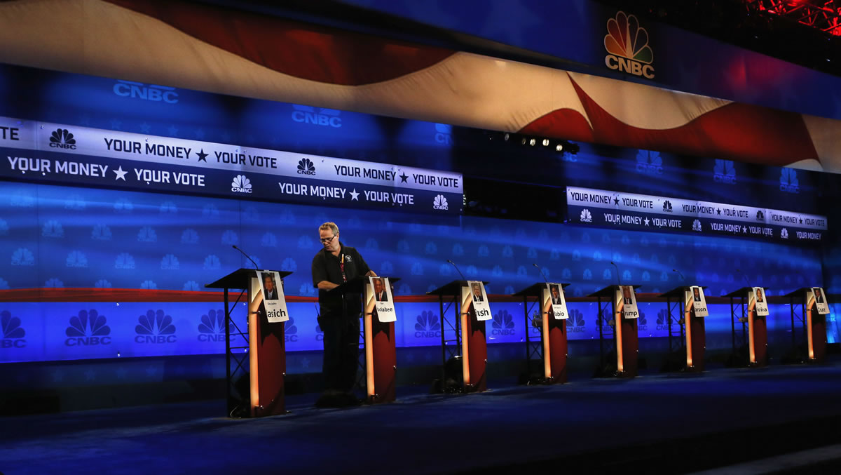 A crew member checks the candidate podiums at the venue for the Oct. 28 CNBC Republican presidential debate, Tuesday, Oct. 27, 2015, inside the Coors Events Center at the University of Colorado in Boulder, Colo. Republican presidential candidates taking the debate stage Wednesday in Colorado are hoping to carry momentum from a 2014 U.S. Senate victory in this toss-up state where independent voters outnumber the electorate from both major parties.