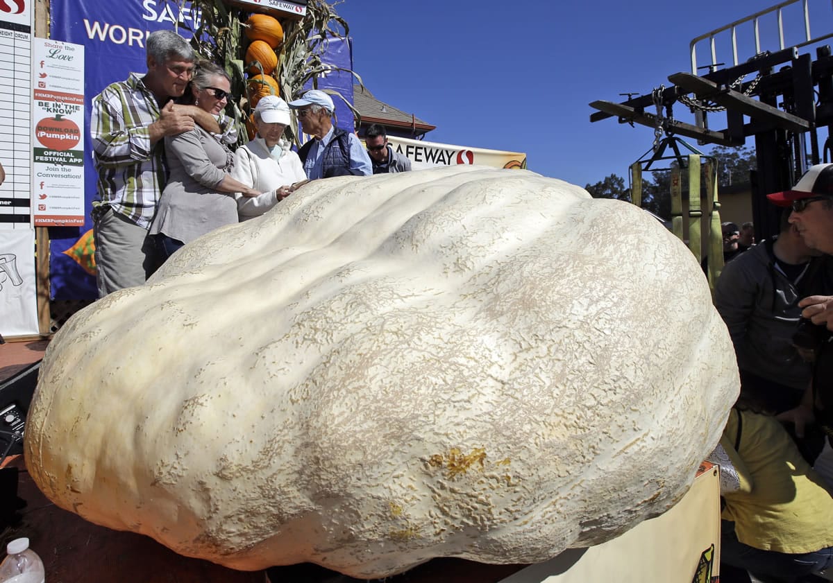 Steve Daletas, left, of Pleasant Hill, Ore., hugs his wife, Susie, after his pumpkin, weighing in at 1969 pounds, won the Annual Safeway World Championship Pumpkin Weigh-Off on Monday in Half Moon Bay, Calif.