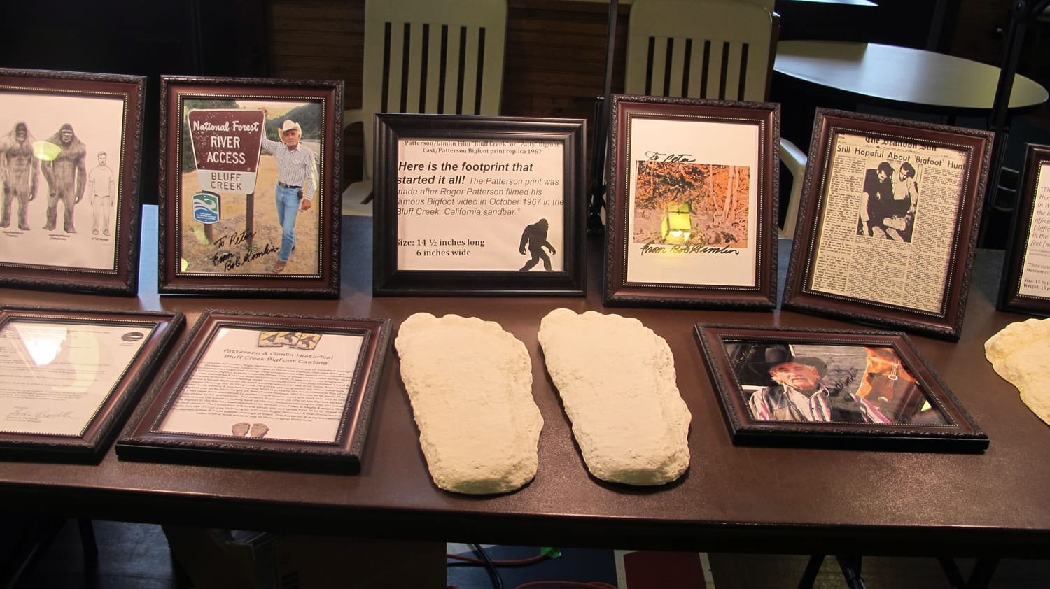 Plaster casts and framed photos line one of the display tables at the 4th annual Chautauqua Lake Bigfoot Expo in Chautauqua, N.Y., on Saturday.  Believers and the curious gather in the rural western New York county to swap stories and hear lectures about the legendary Sasquatch.