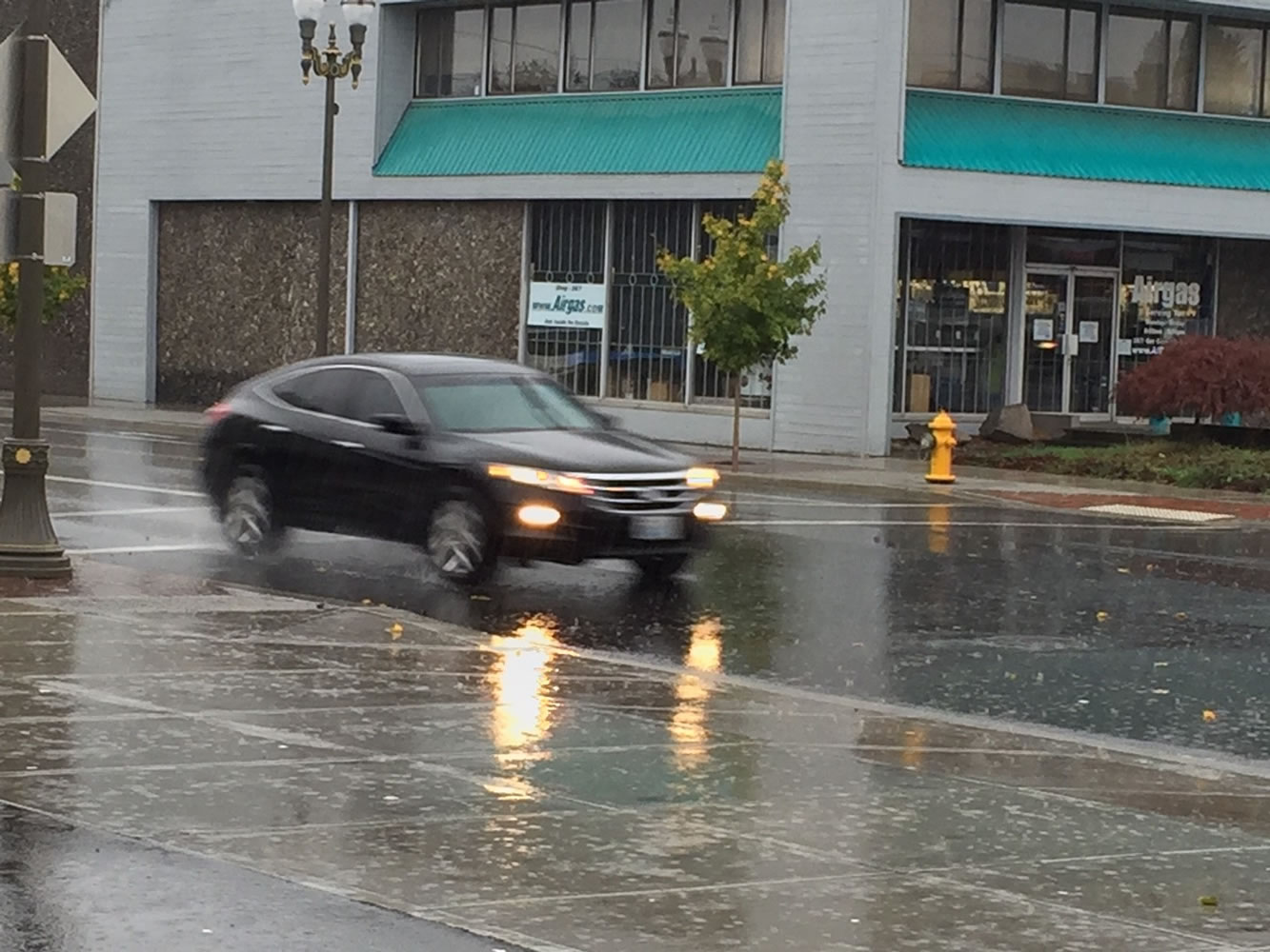 A car speeds down West Eighth Street in Vancouver during Saturday's rainstorm.
