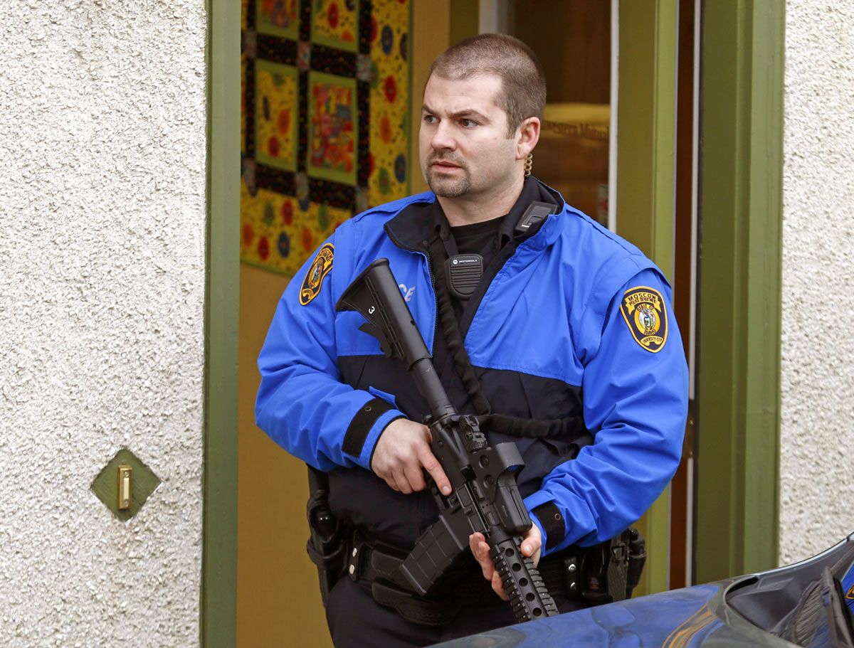 A police officer stands outside an office where two men were shot in Moscow, Idaho, on Saturday.