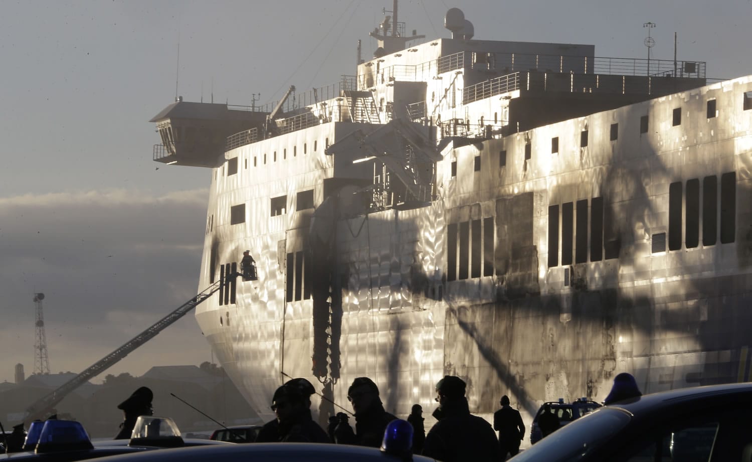 Italian firemen work outside the Norman Atlantic ferry after that has been towed into the port of Brindisi, southern Italy, on Friday.