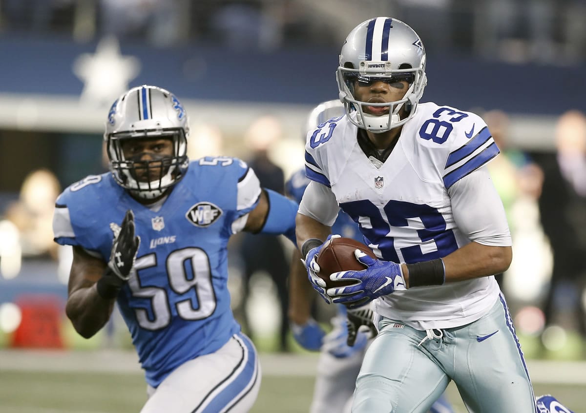 Dallas Cowboys wide receiver Terrance Williams (83) runs back a touchdown against Detroit Lions middle linebacker Tahir Whitehead (59) during the first half of an NFL wildcard playoff game, Sunday, Jan. 4, 2015, in Arlington, Texas.