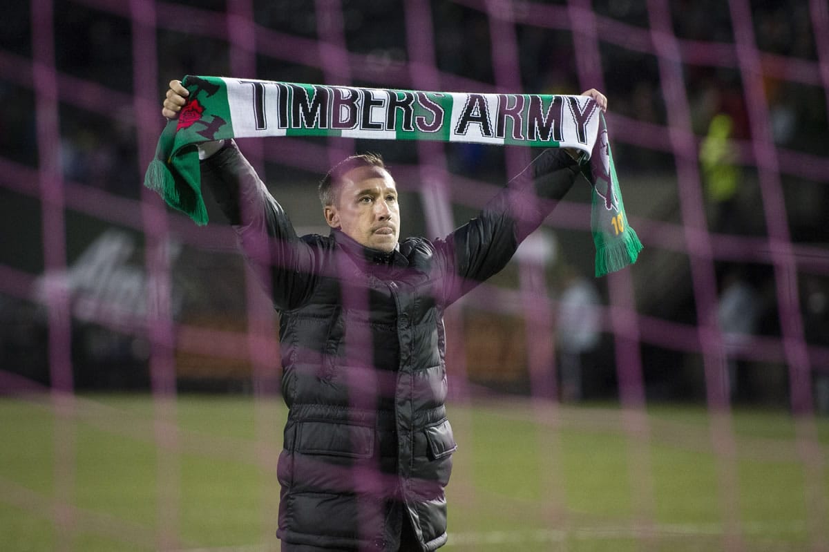 Portland Timbers head coach Caleb Porter celebrates with fans after defeating the Colorado Rapids on Sunday.