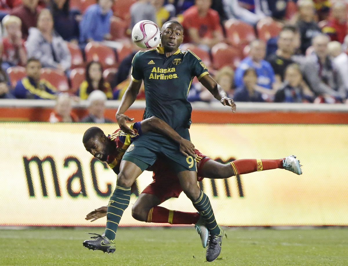 Real Salt Lake&#039;s Aaron Maund falls as he defends Portland  forward Fanendo Adi (9) during the second half Wednesday in Sandy, Utah. The Timbers won 1-0.