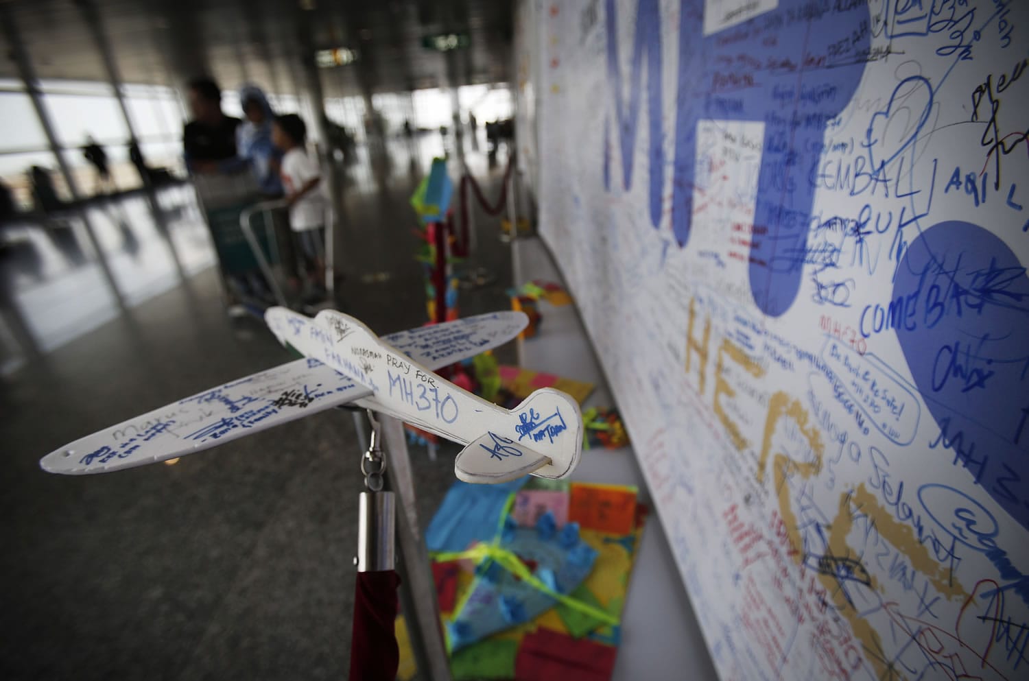 A foam plane with messages and cards with personalized messages dedicated to people involved with the missing Malaysia Airlines jetliner MH370, are placed in the viewing gallery at Kuala Lumpur International Airport, Saturday, March 15, 2014 in Sepang, Malaysia.