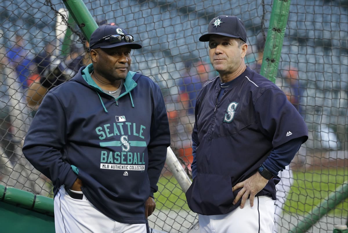 Seattle Mariners manager Lloyd McClendon, left, talks with hitting coach Edgar Martinez, right, during batting practice before a game against the Houston Astros, Tuesday, Sept. 29, 2015, in Seattle. (AP Photo/Ted S.