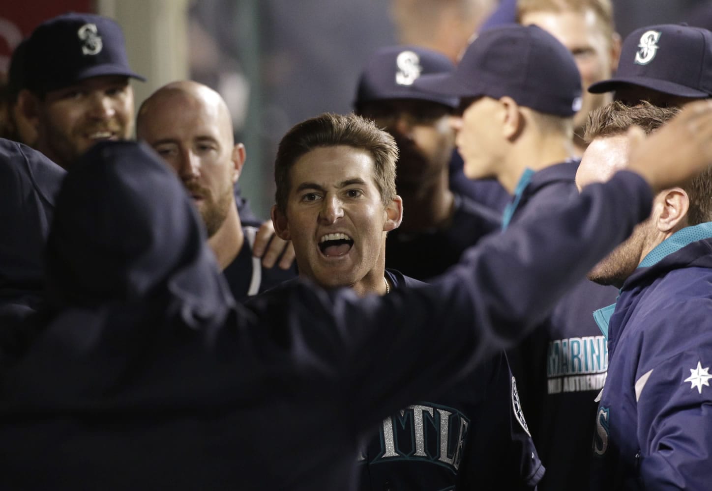 Seattle Mariners' Brad Miller, center, celebrates his two-run home run against the Los Angeles Angels during the ninth inning of a baseball game on Tuesday, April 1, 2014, in Anaheim, Calif. (AP Photo/Jae C.