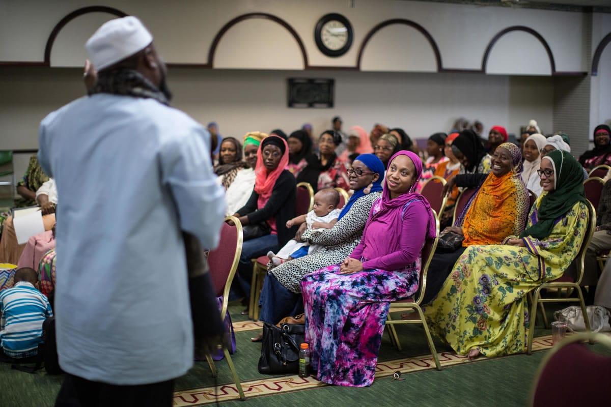 Imam Suleimaan Hamed, left, speaks to members of the Atlanta Masjid of Al Islam mosque in Atlanta. Members of the mosque gathered to celebrate a group of pilgrims who will make the annual Hajj pilgrimage to the holy city of Mecca.