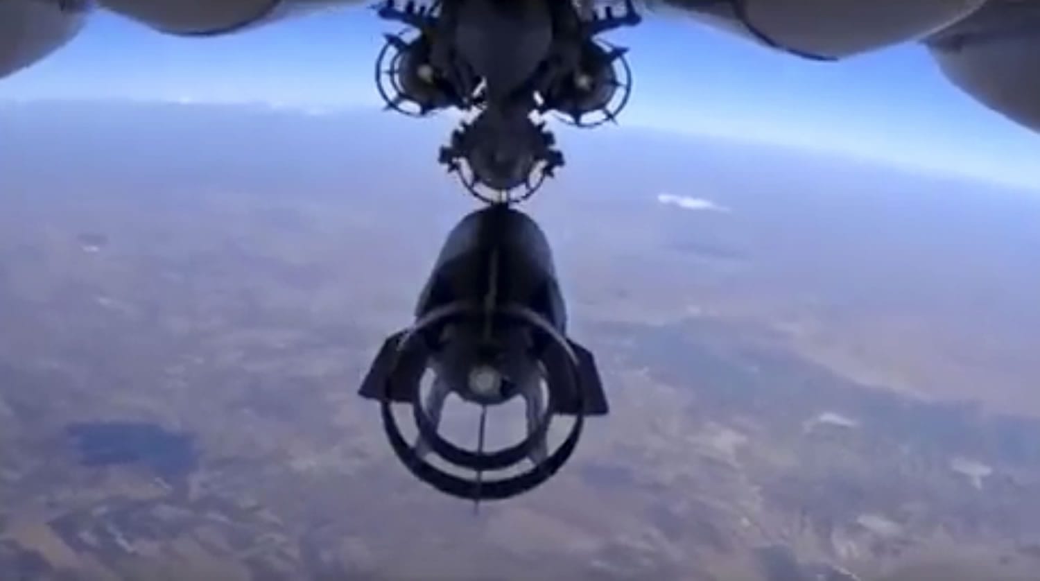 In this photo made from the footage taken from Russian Defense Ministry official website, a bomb is released from Russian Su-24M jet fighter in Syria. NATO strongly criticized the Russian air campaign in Syria that began Wednesday.