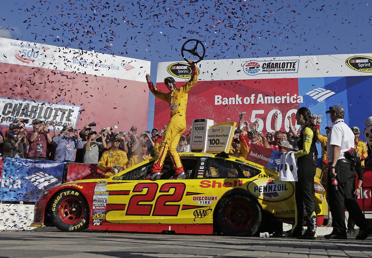 Joey Logano celebrates in Victory Lane after winning the NASCAR Sprint Cup race at Charlotte Motor Speedway in Concord, N.C., Sunday, Oct. 11, 2015.