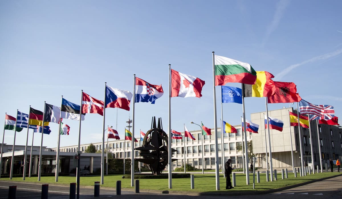 In this Tuesday, Oct. 22, 2013 file photo, flags of member countries flap in the wind in front of NATO headquarters in Brussels. Leaving combat operations in Afghanistan behind, NATO is shifting its focus to Europe in 2015 and the creation of its new ultra-rapid reaction force, designed as a deterrent to Russia.
