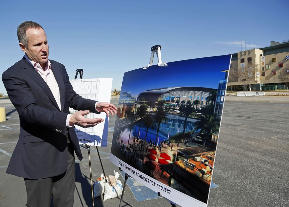Chris Meany, senior vice president of Hollywood Park Land Company unveils an architectural rendering of a proposed NFL stadium at Hollywood Park in Inglewood, Calif., Monday, Jan. 5, 2015.