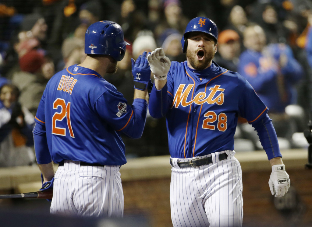 New York Mets' Daniel Murphy is congratulated by teammate Lucas Duda after hitting a two-run home run during the first inning of Game 2 of the National League baseball championship series against the Chicago Cubs Sunday, Oct. 18, 2015, in New York. (AP Photo/David J.