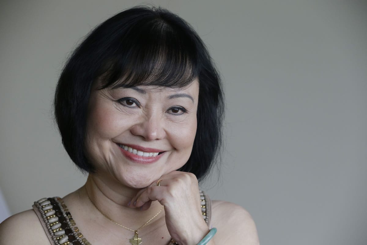 In this Sept. 25, 2015 photo, Kim Phuc poses for a photo at a hotel in Miami. Phuc arrived from her home in Canada to undergo a series of laser treatments to reduce the scars and pain she has endured for 40 years following an attack on her village during the Vietnam war.