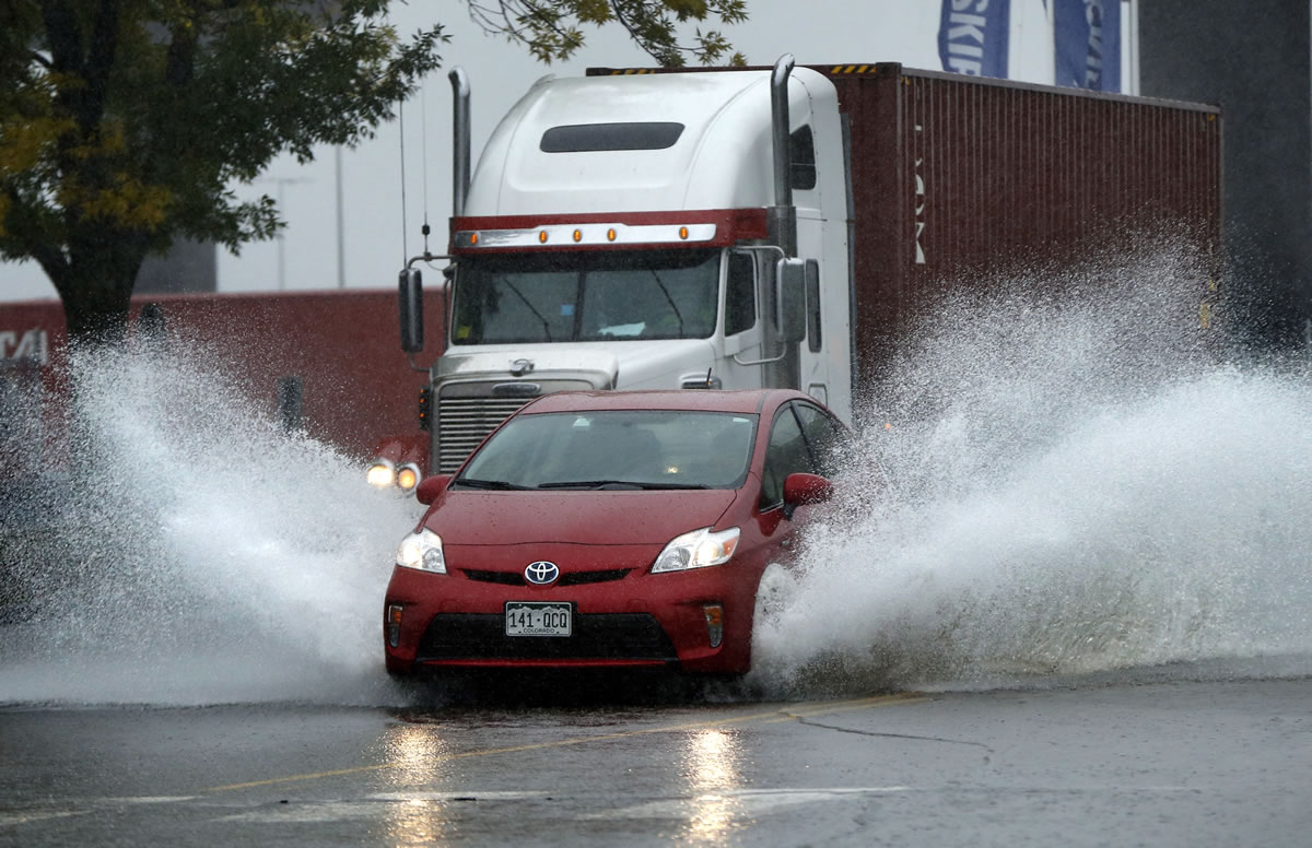 A motorist drives through flooding water in Portland, Maine, on Wednesday. Heavy rain has been moving through northern New England and a flood warning was issued for parts of Maine and New Hampshire. (AP Photo/Robert F.