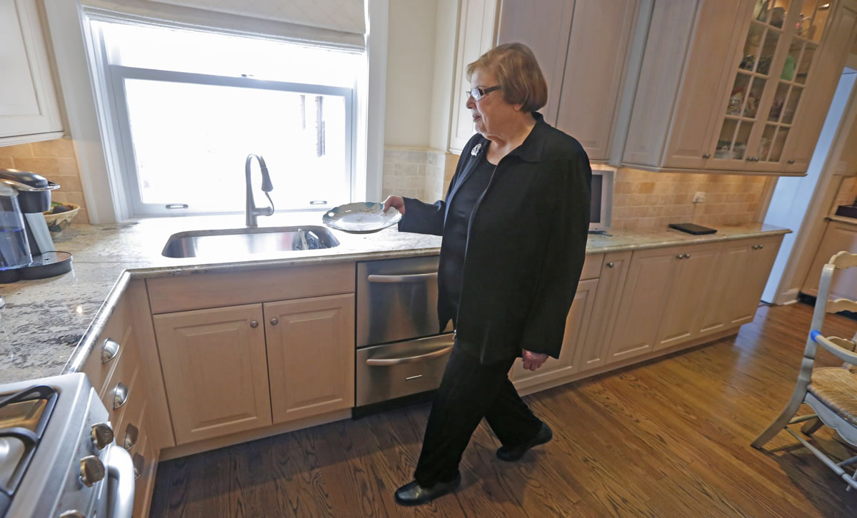 Mary Ann Tuft, 79, walks in her apartment in Chicago.