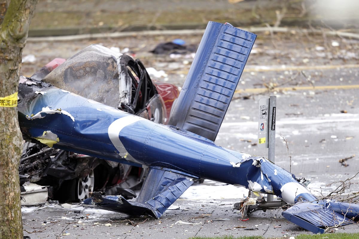 Associated Press files
The wreckage of a news helicopter sits on a city street after crashing in this March 18 in Seattle.