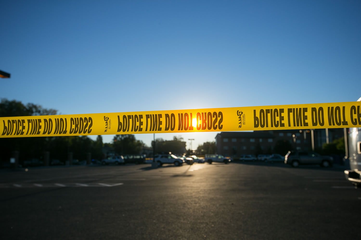 Police tape stretches across a section of street by Northern Arizona University campus in Flagstaff, Ariz., on Friday, Oct. 9, 2015,  after an early morning fight between two groups of college students escalated into gunfire leaving one person dead and three others wounded, authorities said.