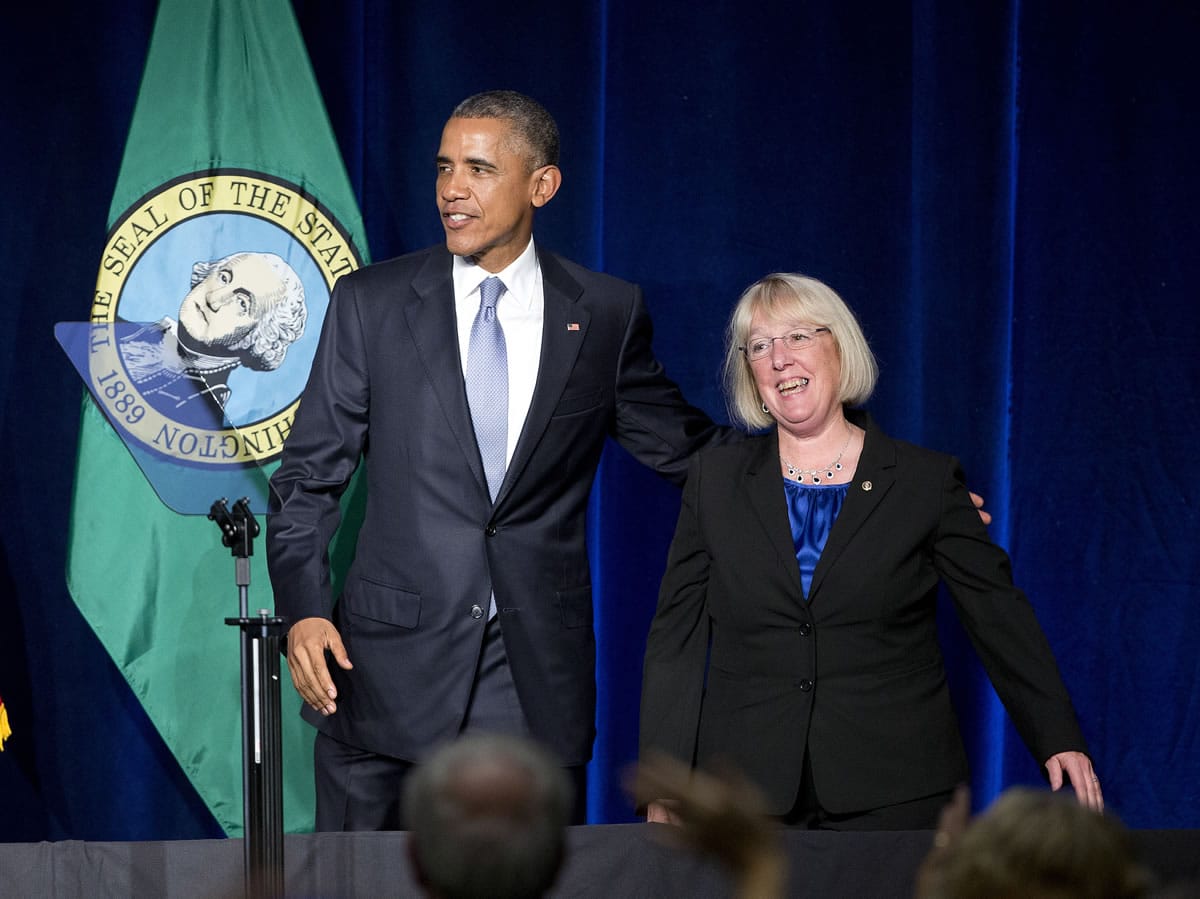 President Barack Obama puts an arm around Sen. Patty Murray, D-Wash., as they walk off stage after speaking at a Democratic fundraiser Friday in Seattle.