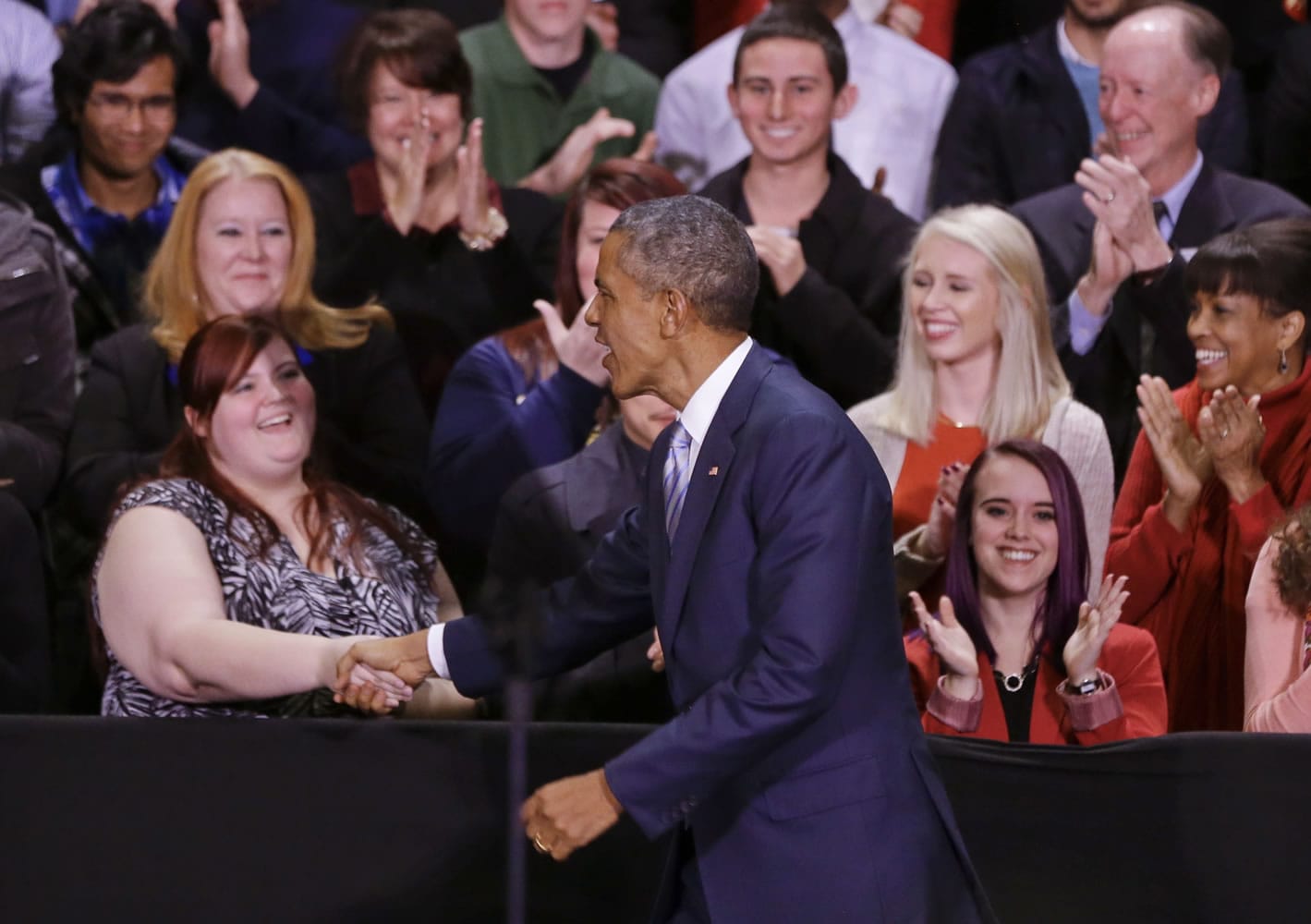 President Barack Obama greets people on stage as he arrives to speak at Pellissippi State Community College on Friday in Knoxville, Tenn.