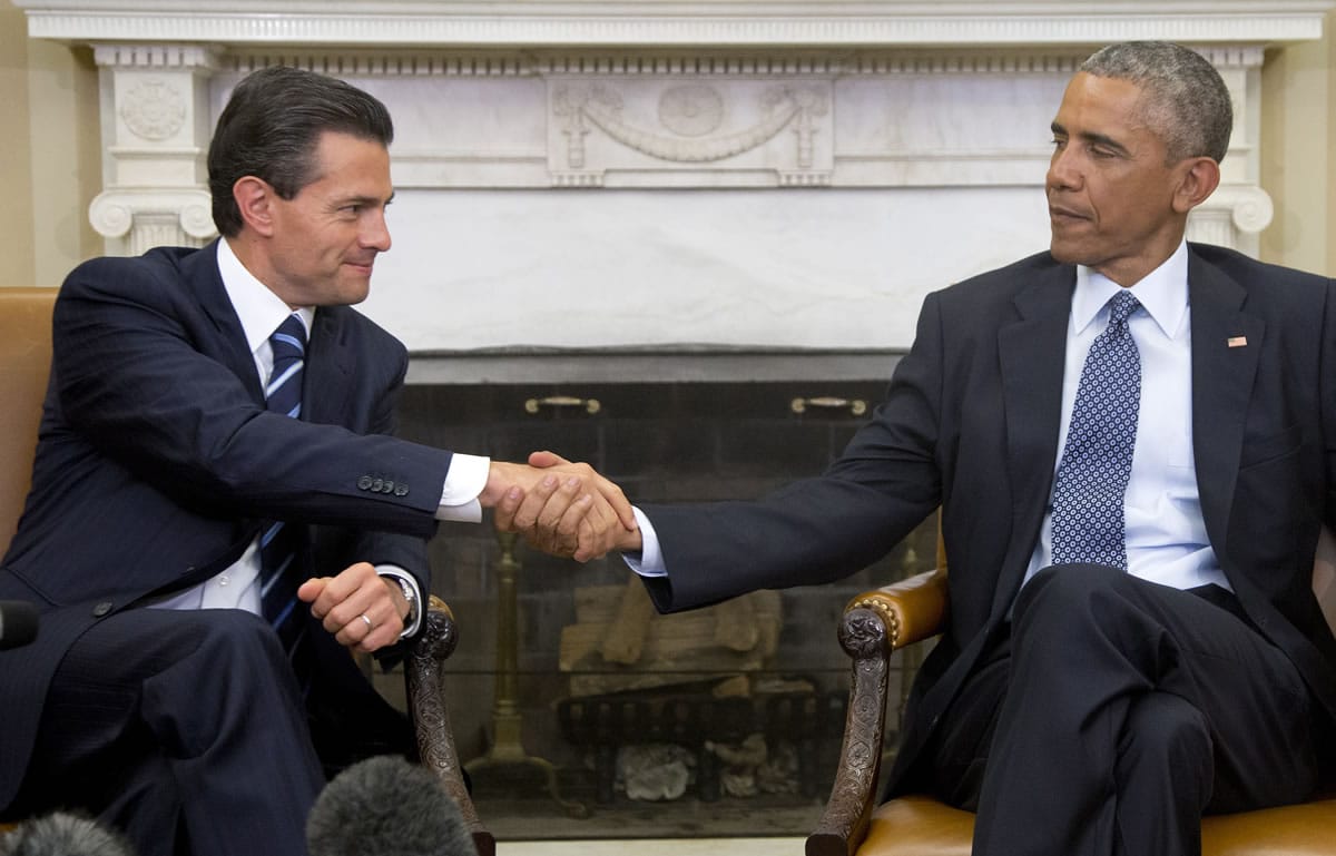 President Barack Obama and Mexican President Enrique Pena Nieto shake hands after speaking to the media in the Oval Office of the White House in Washington on Tuesday.