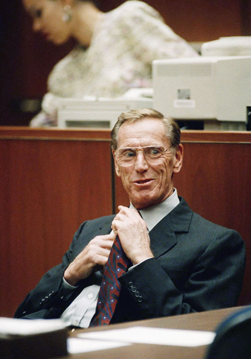 Charles Keating Jr. adjusts his tie as he sits in a Los Angeles courtroom on Nov. 14, 1991. Keating, the financier who was disgraced for his role in the costliest savings and loan failure of the 1980s, has died.