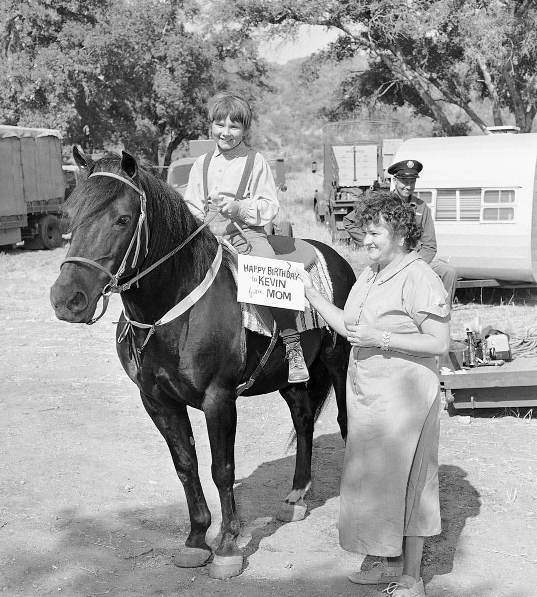 Ten-year-old Kevin Corcoran tries out his birthday present on June 10, 1959, at a party during the filming of &quot;Toby Tyler.&quot; The horse was a gift from his mother.