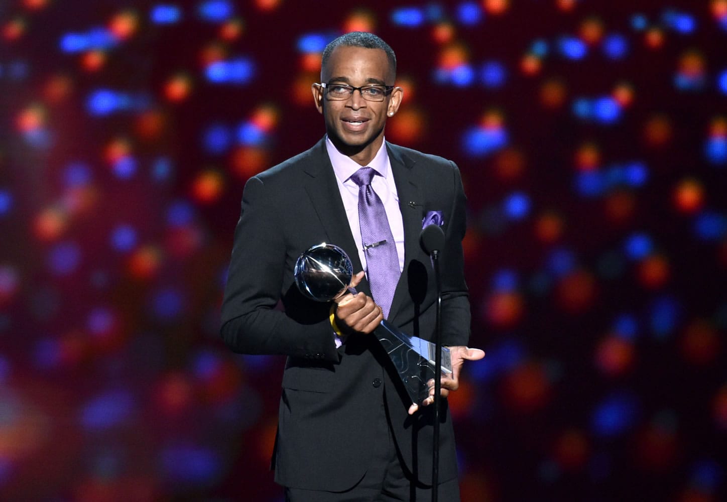 ESPN sportscaster Stuart Scott accepts the Jimmy V award for perseverance, at the ESPY Awards on July 16, 2014, at the Nokia Theatre, in Los Angeles. Scott, the longtime &quot;SportsCenter&quot; anchor and ESPN personality known for his known for his enthusiasm and ubiquity, died Sunday, Jan. 4, 2015 after a long fight with cancer. He was 49.