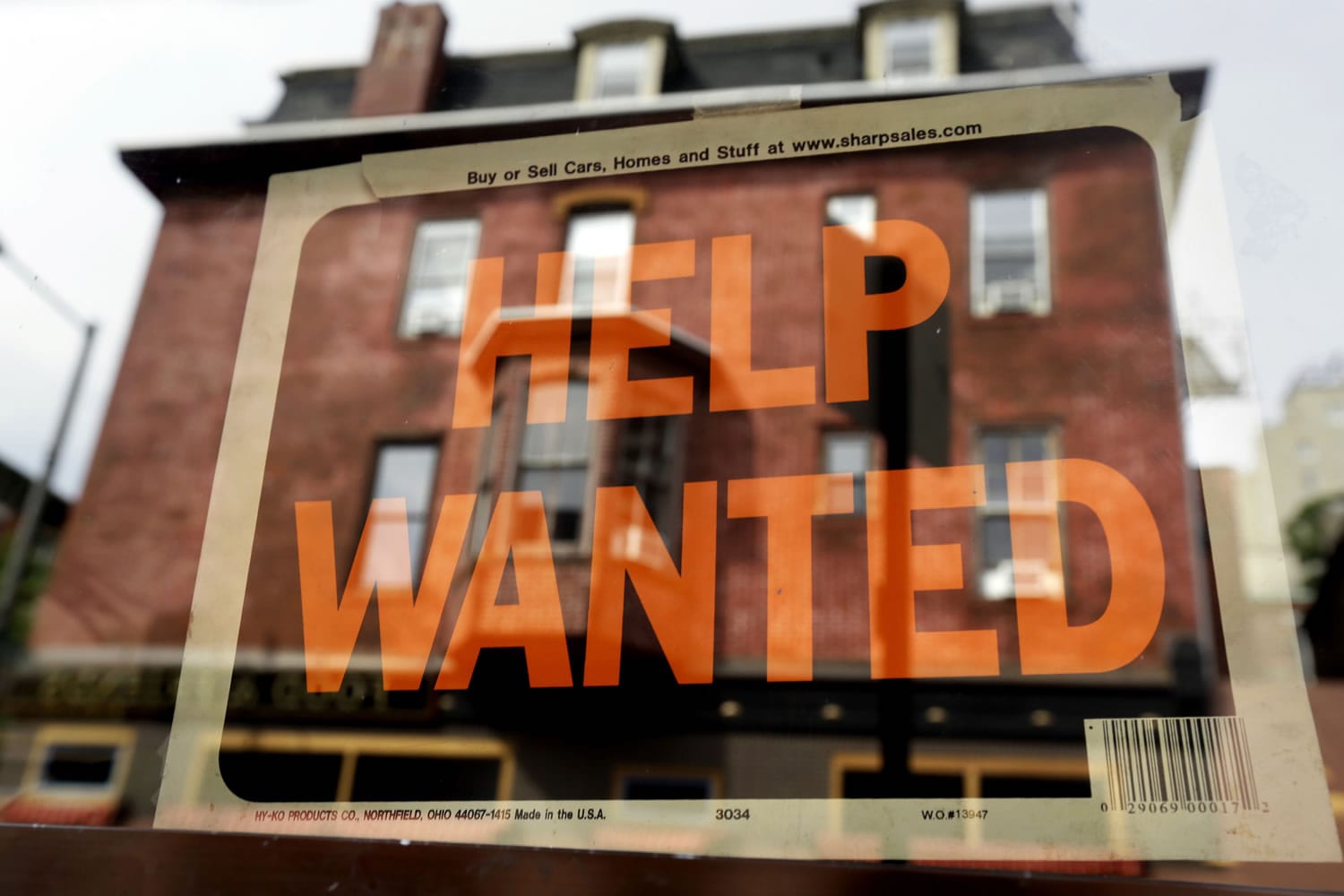 A Philadelphia business displays a help wanted sign in its storefront in August 2013.