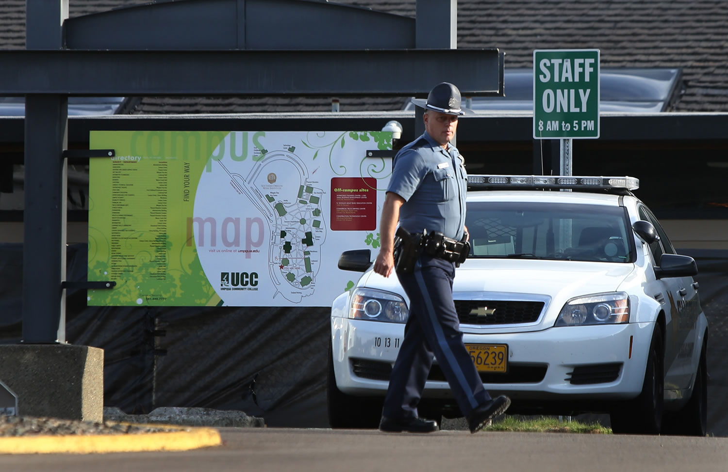 An Oregon State Patrol Trooper walks the grounds of Umpqua Community College near Roseburg, Ore., on  Tuesday in the aftermath of the mass shooting on the Roseburg campus.