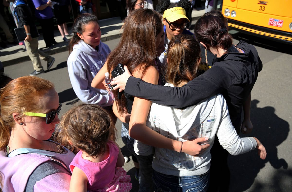 Friends and family are reunited with students at the local fairgrounds after a mass shooting at Umpqua Community College, in Roseburg, Thursday, Oct. 1, 2015. Multiple people were killed after a gunman opened fire at the campus early Thursday.
