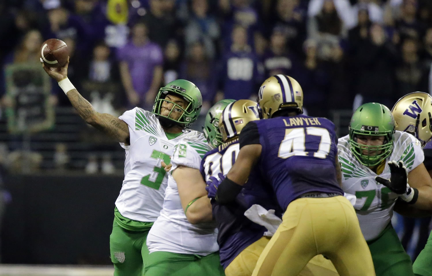 Oregon quarterback Vernon Adams Jr., left, passes around his blockers in the first half of an NCAA college football game against Washington, Saturday, Oct. 17, 2015, in Seattle. (AP Photo/Ted S.