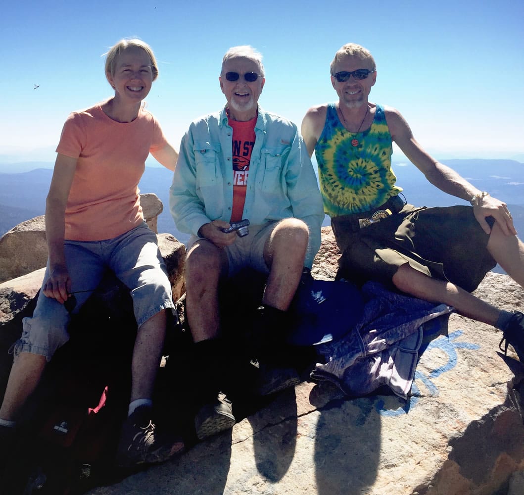 Art Ekerson, center, sits Sept. 15 on the summit of Mount McLoughlin for his 80th birthday near Butte Falls, Ore., with his daughter, Cheryl Krieg, left, and son Kevin Ekerson, 45 years after the first time he led them to the summit. The 11-mile round trip on Mount McLoughlin was his 42nd trip to the top of the mountain.