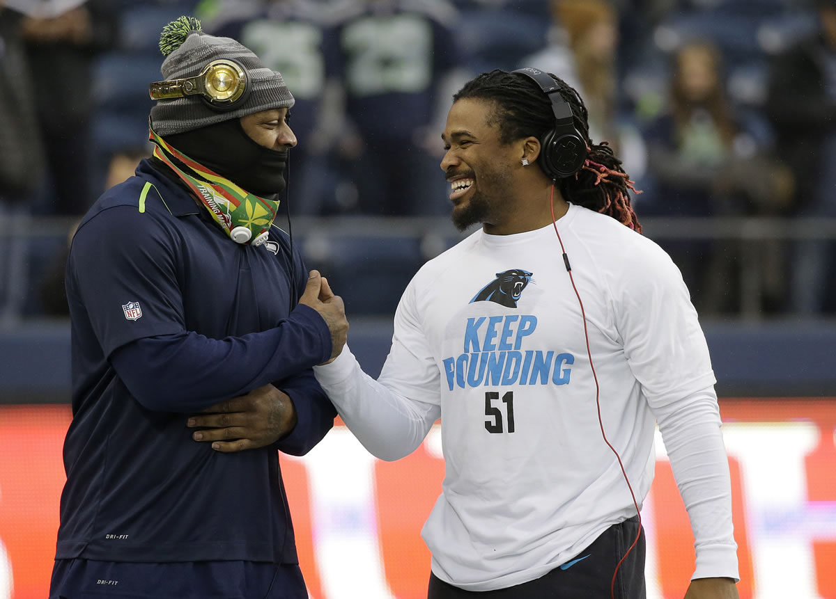Seattle Seahawks running back Marshawn Lynch, left, shakes hands with Carolina Panthers running back DeAngelo Williams before an NFL divisional playoff football game in Seattle on Saturday.