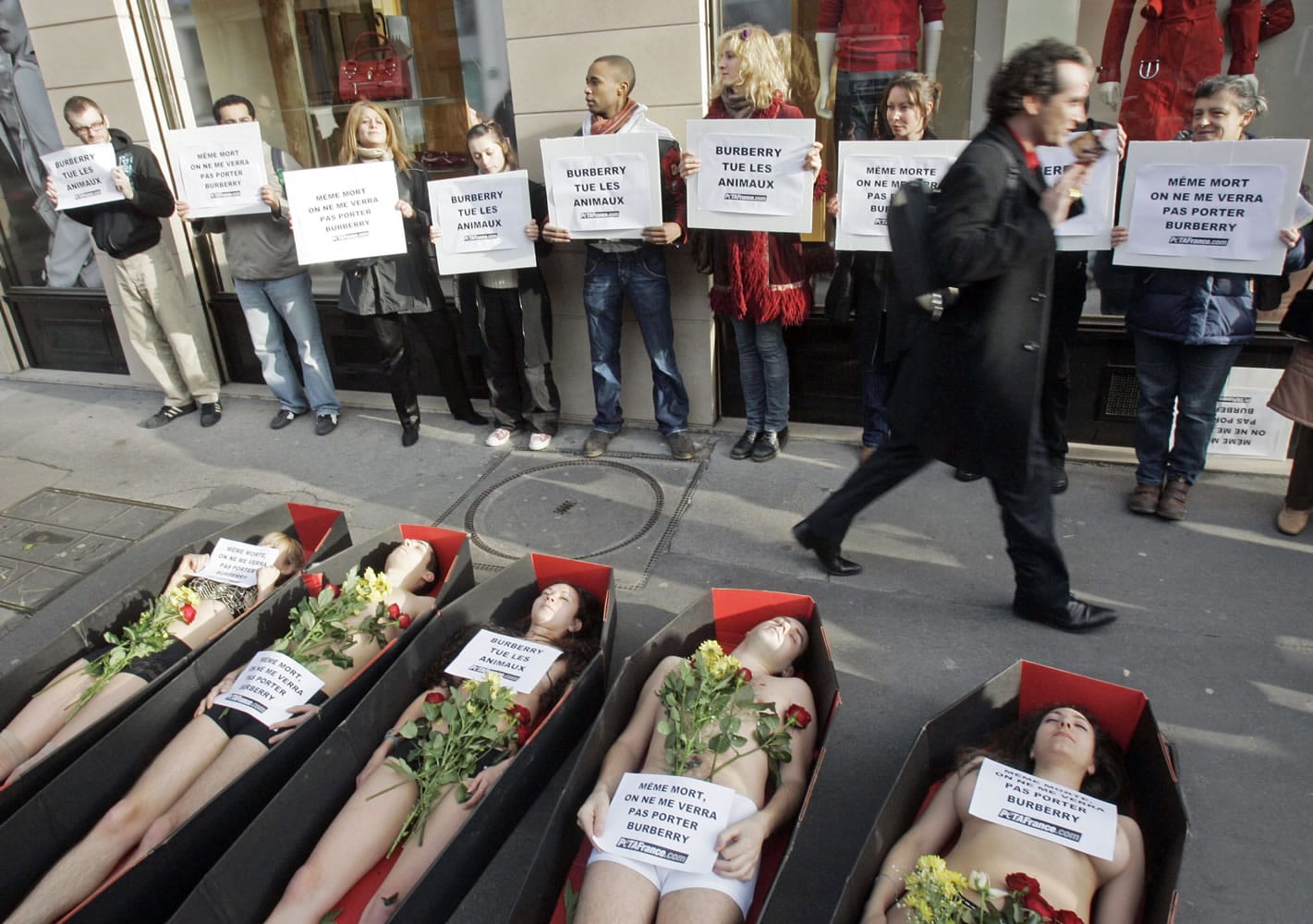 People for the Ethical Treatment of Animals demonstrators lie in fake coffins, staging a Jan. 15, 2007, protest against the use of fur by the British fashion house Burberry in Paris.