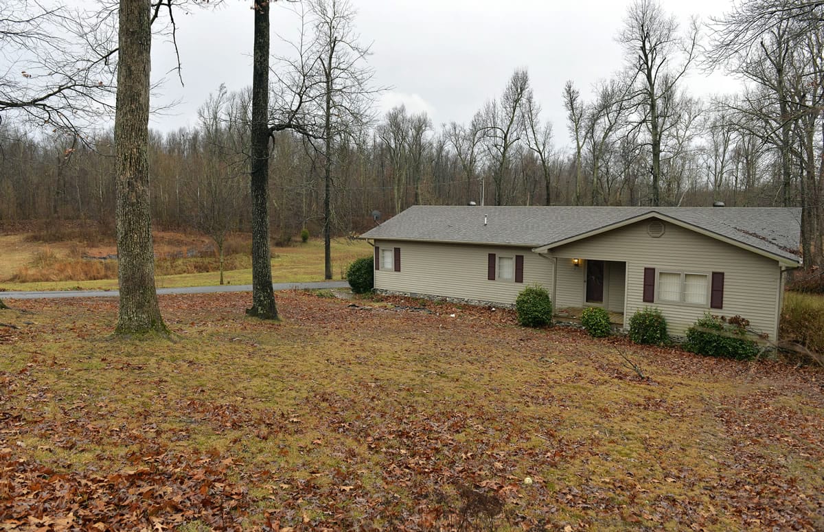 Larry Wilkins' home is nestled in woods in Kuttawa, Ky., a mile from where a small plane crashed Friday, killing four.