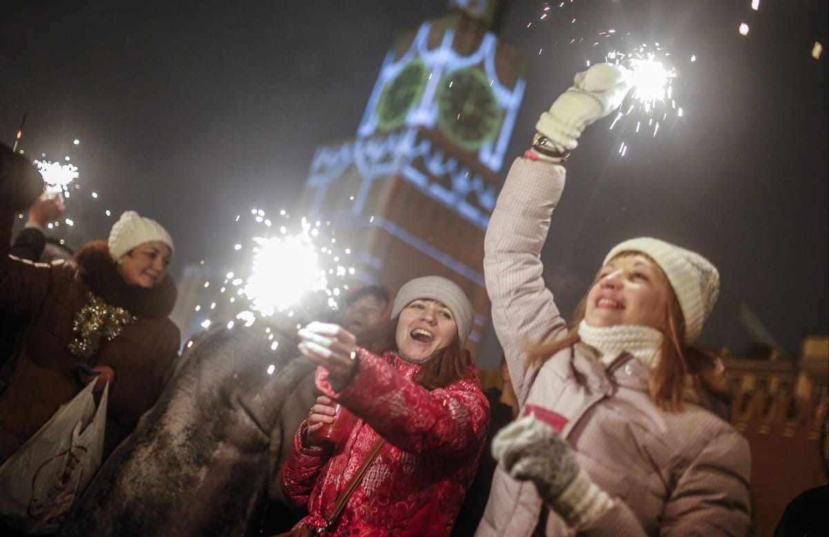 People wave sparklers as they celebrate the New Year on Thursday at Red Square in Moscow, Russia.