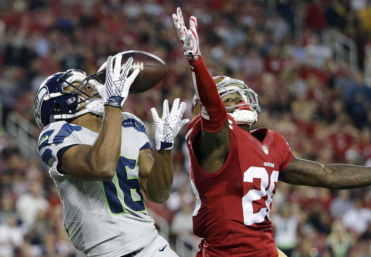 Seattle Seahawks wide receiver Tyler Lockett (16) catches a touchdown pass in front of San Francisco 49ers cornerback Tramaine Brock (26) during the first half of an NFL football game in Santa Clara, Calif., Thursday, Oct. 22, 2015.