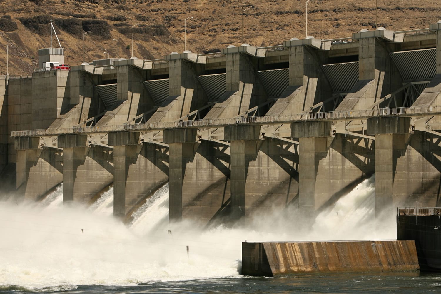 Water pours out of the Lower Granite Dam on the Snake River in July 2006 near Pomeroy. Farmers, shippers and other dam supporters fiercely defend the structures as keys to the region&#039;s economy.