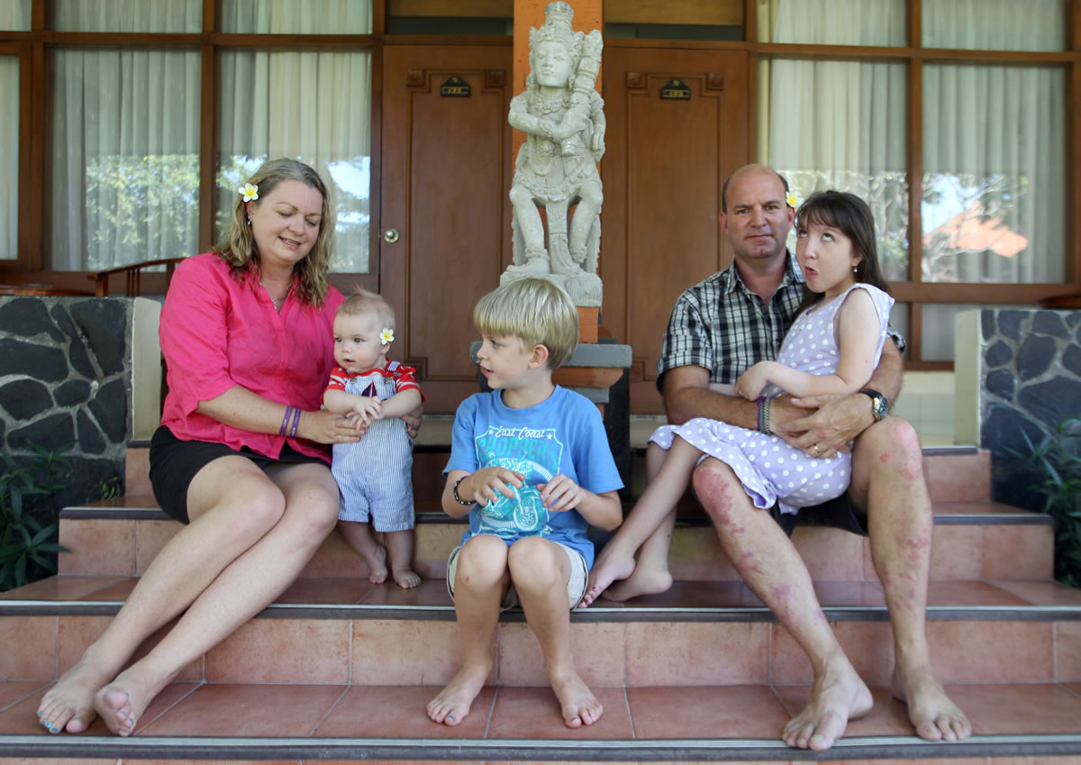 Jenn, left, and Mark Hooper sit for a photo Aug. 12 with their three children, from left, Cody, Zak and Charley, in Bali, Indonesia. Mark quit his job as an architectural draftsman to help Jenn with the kids.