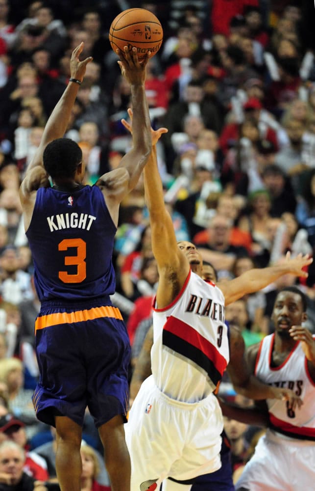 Phoenix Suns guard Brandon Knight (3) hits a three-point shot over Portland Trail Blazers guard C.J. McCollum (3) during the fourth quarter of an NBA basketball game against the Portland Trail Blazers in Portland, Ore., Saturday, Oct. 31, 2015. The Suns won the game 101-90.