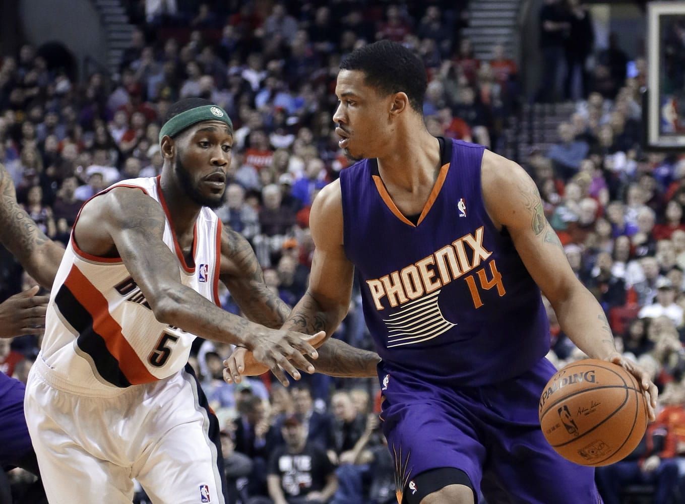 Phoenix Suns forward Gerald Green, right, dribbles against Portland Trail Blazers guard Will Barton during the first half of an NBA basketball game in Portland, Ore., Friday, April 4, 2014.