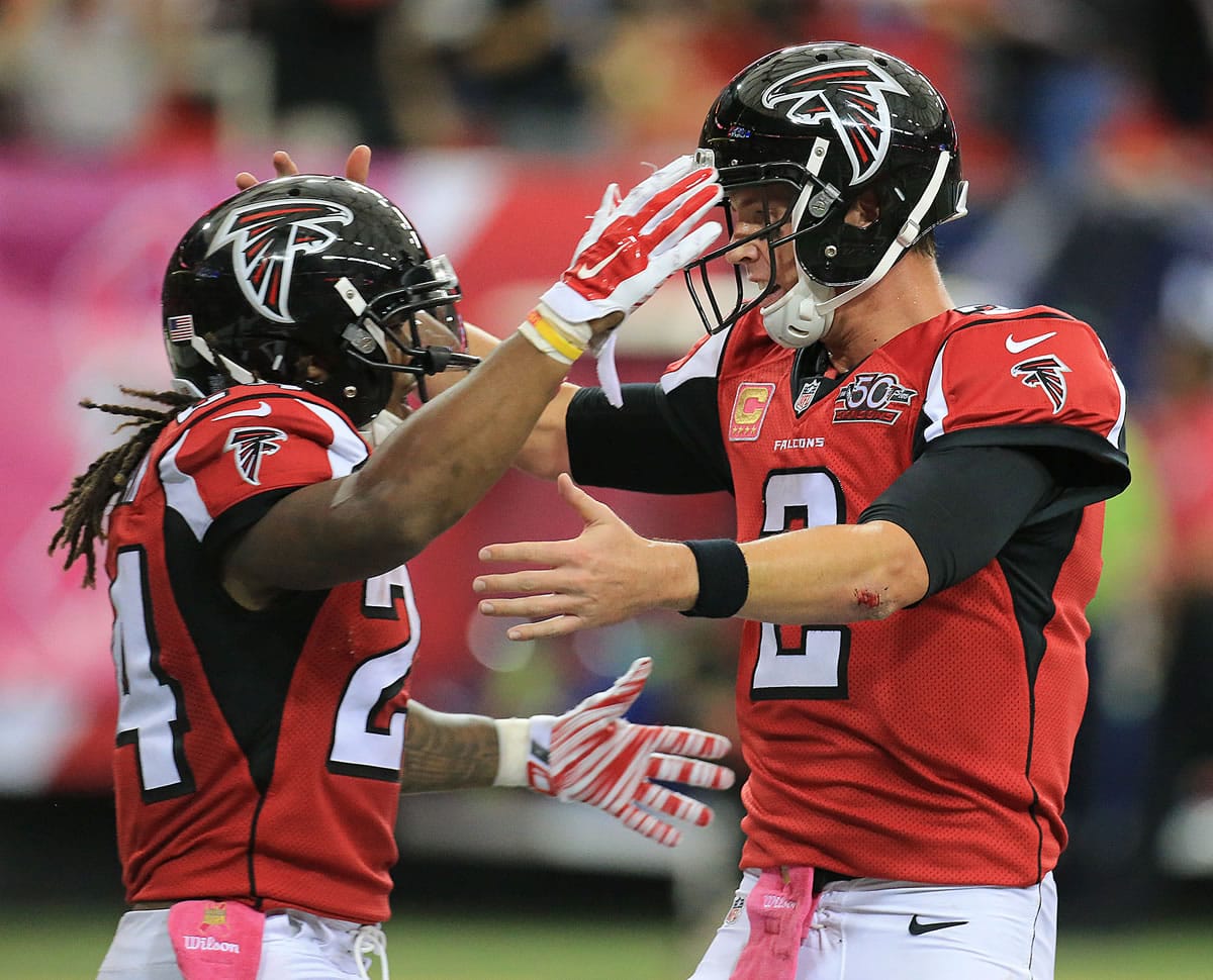 Falcons running back Devonta Freeman, left, celebrates his second touchdown run of the day with quarterback Matt Ryan during the second quarter of their NFL football game against the Texans in Atlanta on Sunday, Oct. 4, 2015.